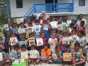 Children at Ulutuya school on Goodenough Island display the books they received.