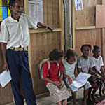 Head teacher Bernard Karad with Grade 2 students.