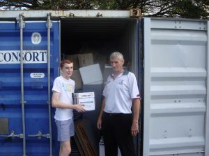 Grade 8 boy Daniel White and Harry Graepel load the container at St Mary's in Cairns. Daniel's friend Noah Law also helped.